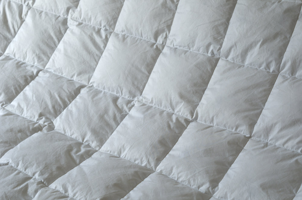 A closeup of a baffle box construction of a duvet ensuring its even warmth distribution while allowing the down to loft fully.