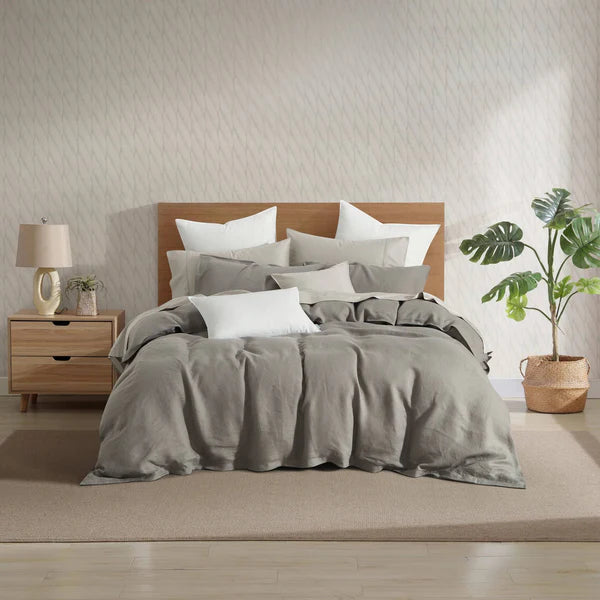 Bedroom with French Linen Duvet Cover Set, wooden headboard, and side table.