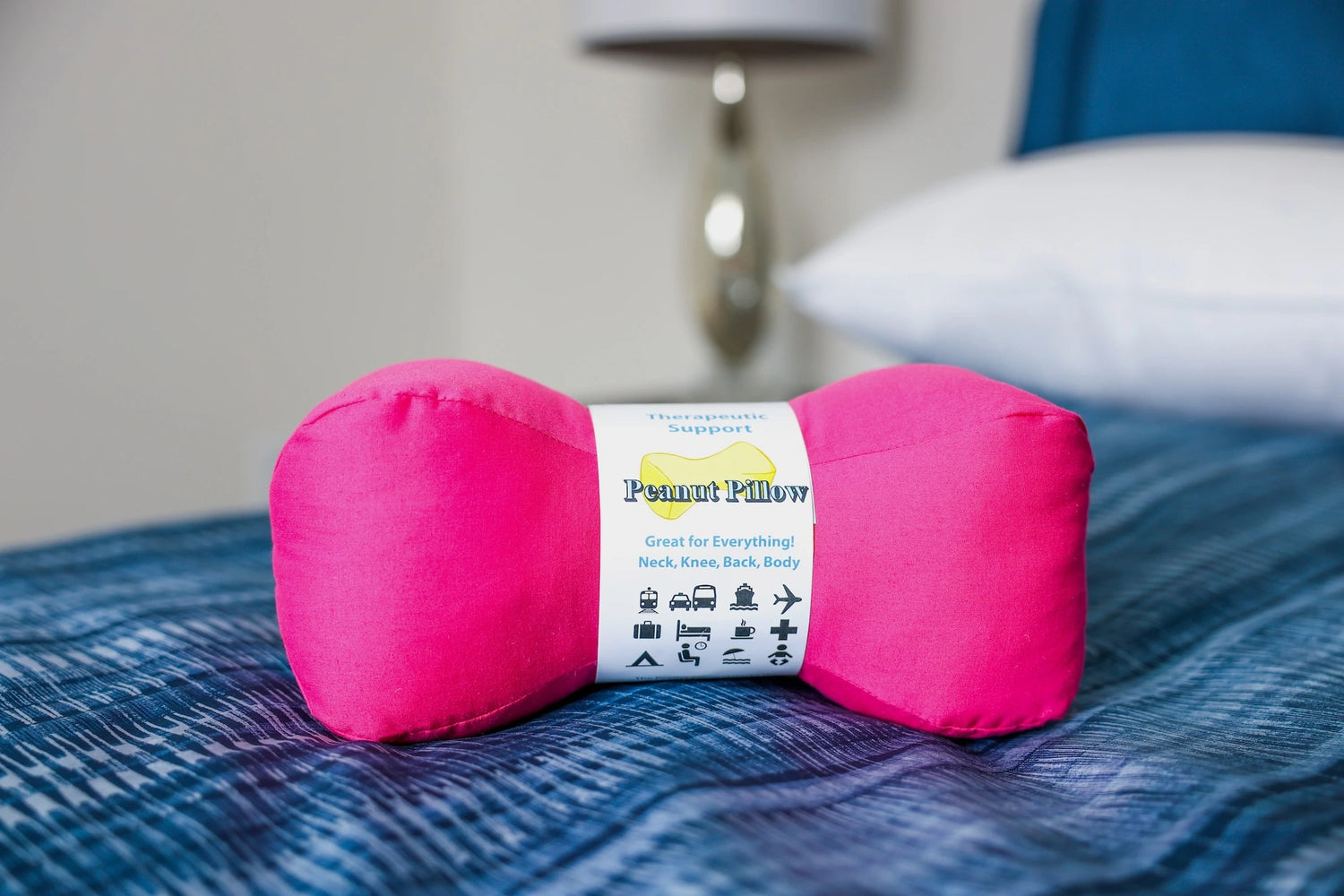 Peanut pillow perfect for travelling in pink color.
