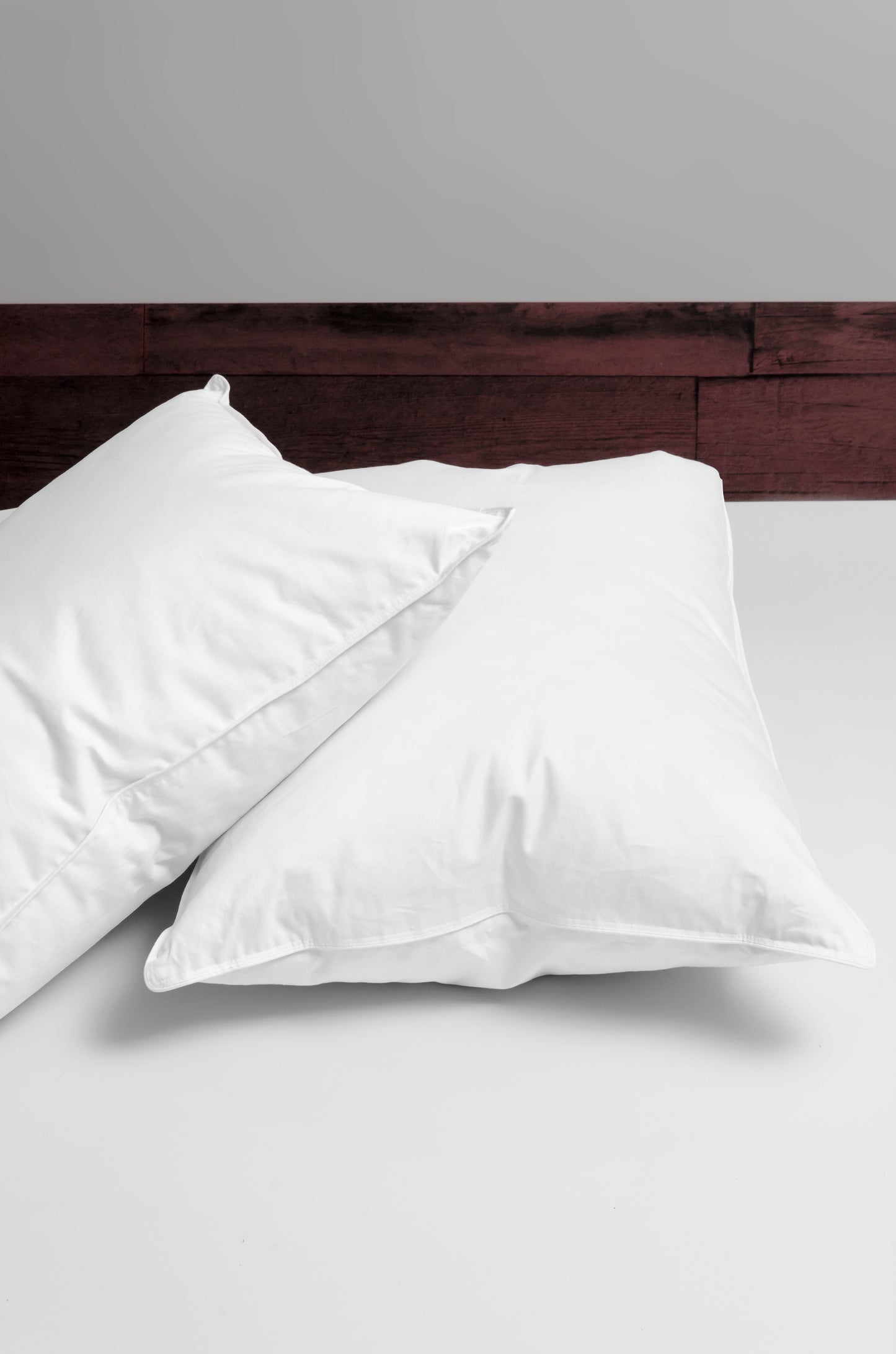 Pure down classic pillows on a bed.