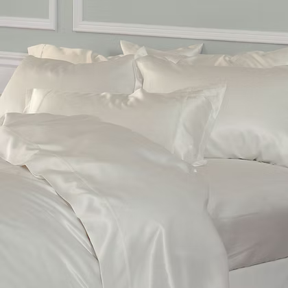 White satin Avorio | Silk Duvet Cover Set on a bed with a neutral background