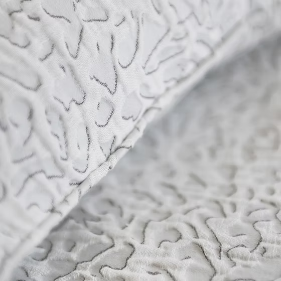 Close-up of textured white Athena Jacquard Duvet Cover Set with a subtle pattern