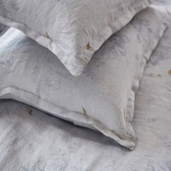 Close-up of textured Fortuna Jacquard pillows on a matching fabric background