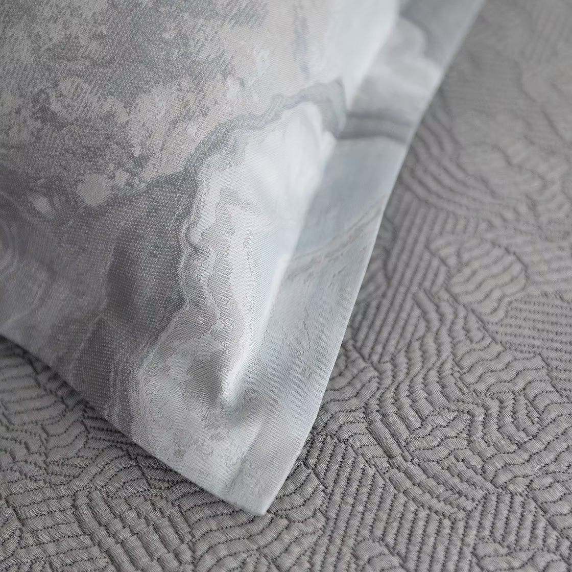 Close-up of textured gray fabric of a Opus Jacquard Duvet Cover.