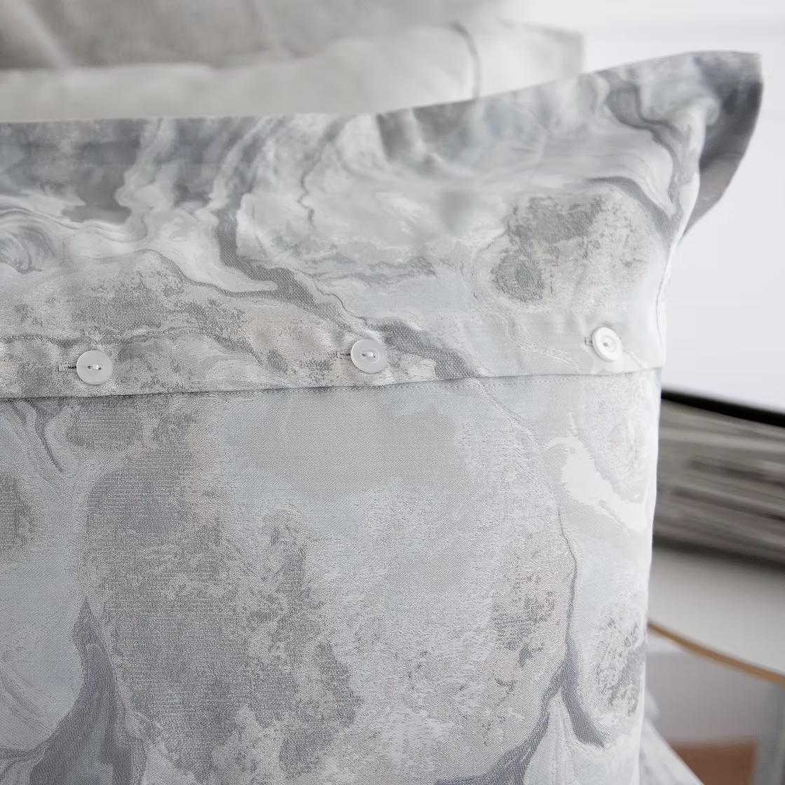 Close-up of a Opus Jacquard Duvet Cover
pillow with a blurred background
