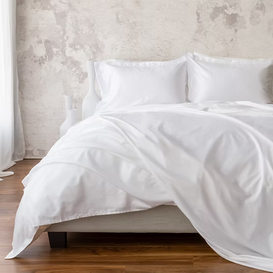 White Giza 92 Classic | Sateen bedding set on a bed with a neutral wall background