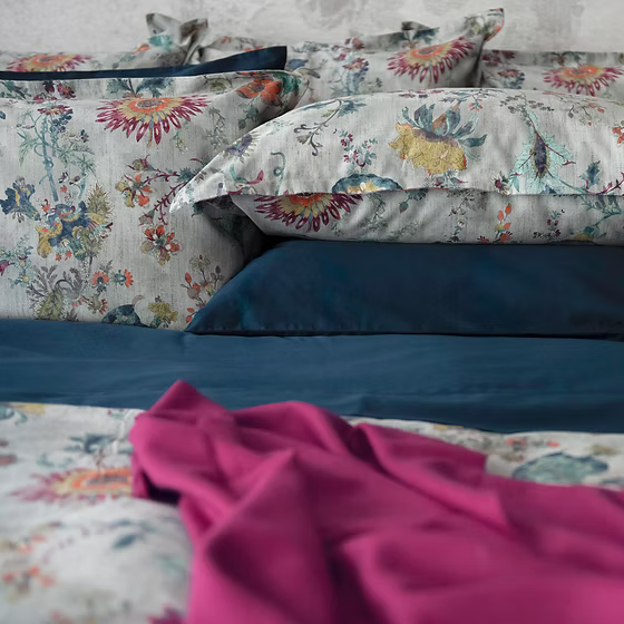 Floral Morgan sateen bedding set with a pink throw on a bed.