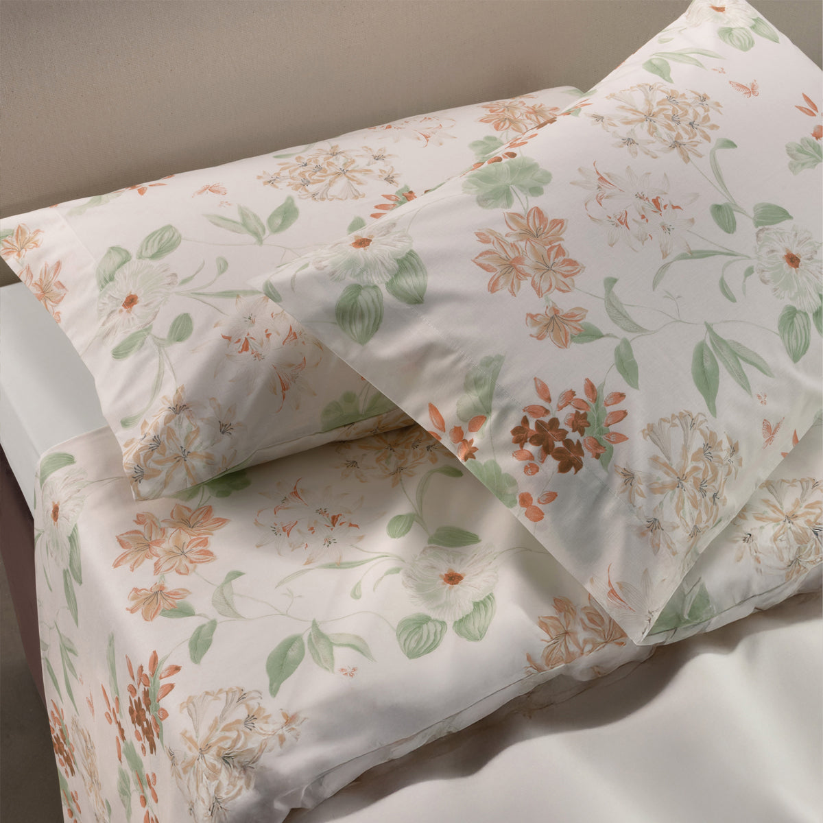 Floral-patterned Brillante Sheets & Pillowcases on a bed with a neutral background