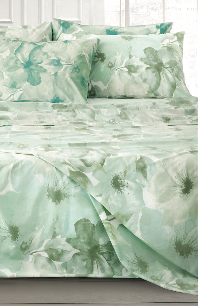 Green floral Odette Percale Bedding Set on a bed in a bedroom
