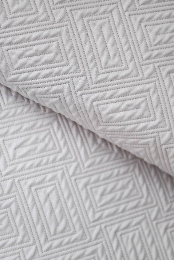 A closeup on a Scala Matelassé - Cushions Knife Edge - sold by Guildcraft