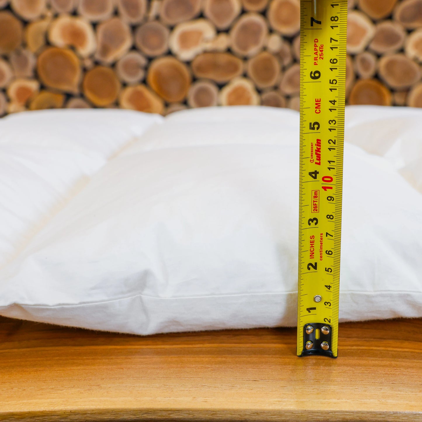 A measuring tape showing thickness of a medium weight down duvet.