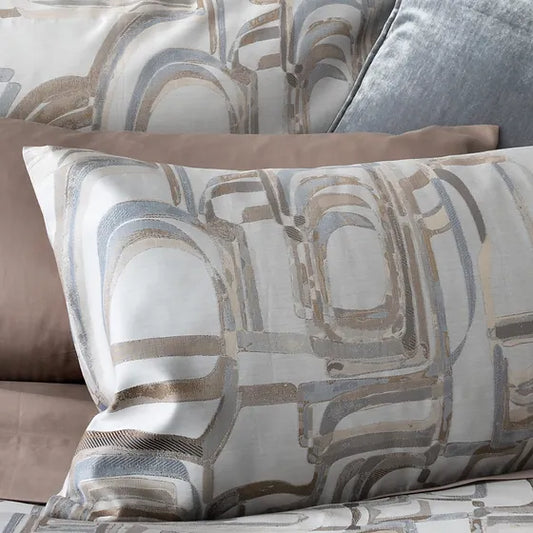 A close-up of a beige and brown Fjord  jacquard pillow sham with a geometric pattern.