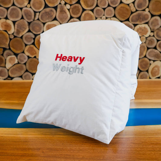 Heavy weight duvet neatly folded in front of a wooden wall.
