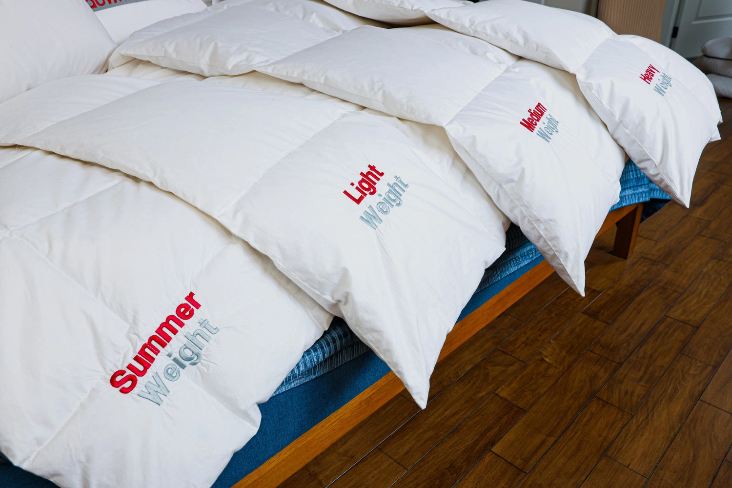 Spread of duvet of all weights on a bed with a focus on light weight duvet.