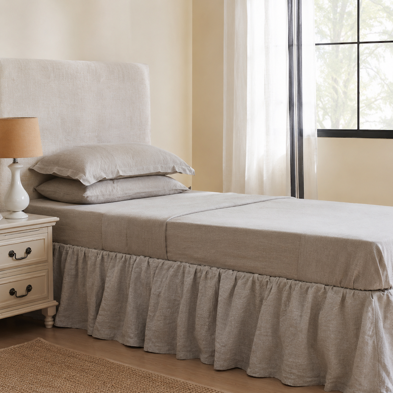 Neatly made bed with French Linen Sheet Set in a bedroom setting.