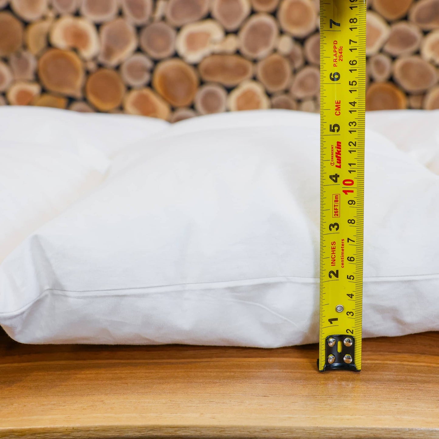 A measuring tape showing the thickness of a heavy weight down duvet.