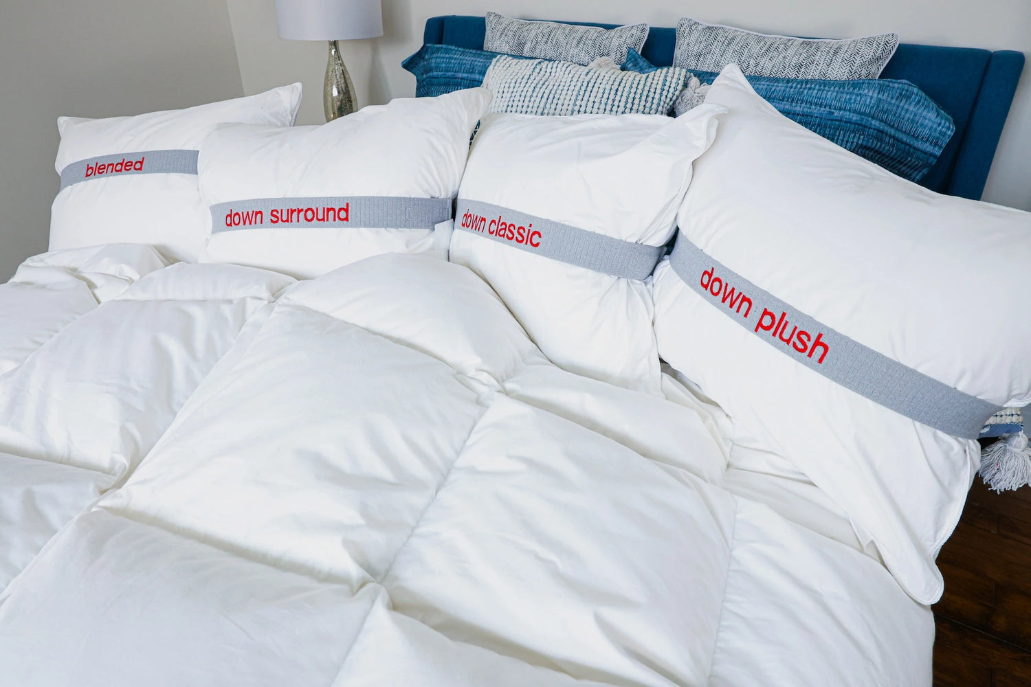 Guildcraft pillows on a bed with blue bedding.