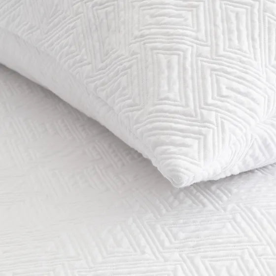 A closeup on a Scala | Matelassé White Coverlet