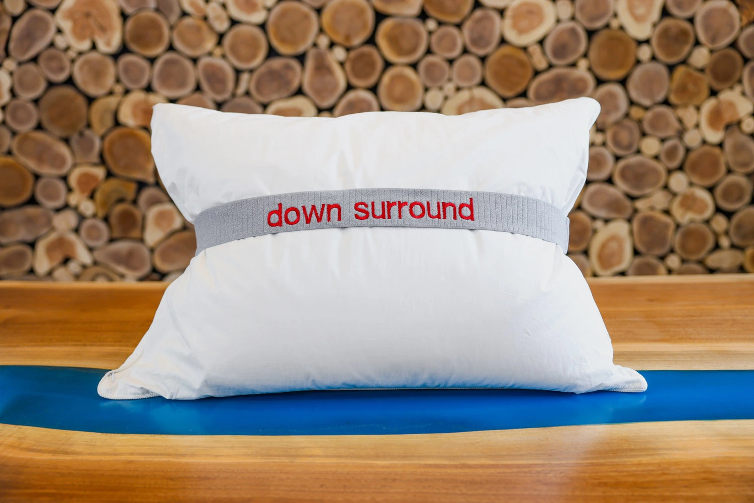 A down surround pillow fluffed and put on a table.