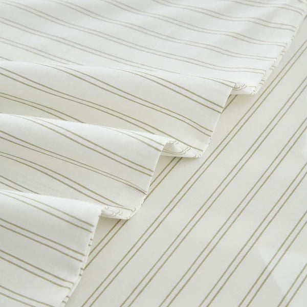 Close-up of striped Vale Green Duvet Cover Set with pillows on a white background