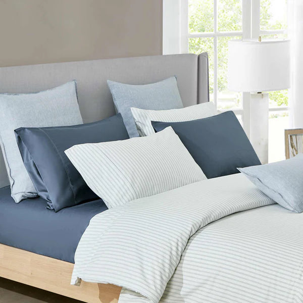 Bed with blue and gray Vale Shadow Duvet Cover Set in a bright room