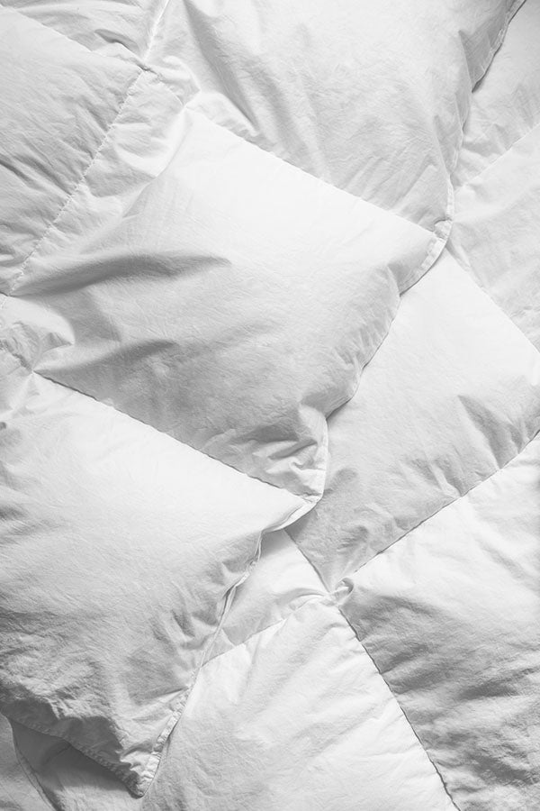 A closeup on cotton shell of a down duvet.