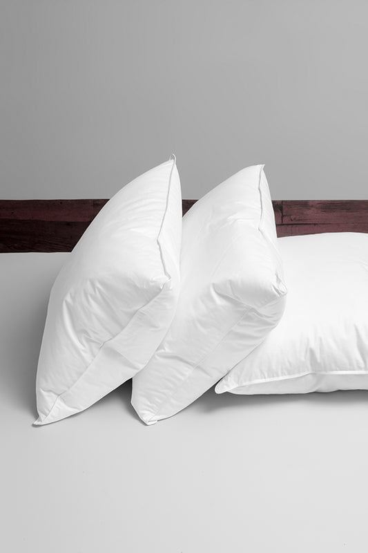 Down pillows on a bed.